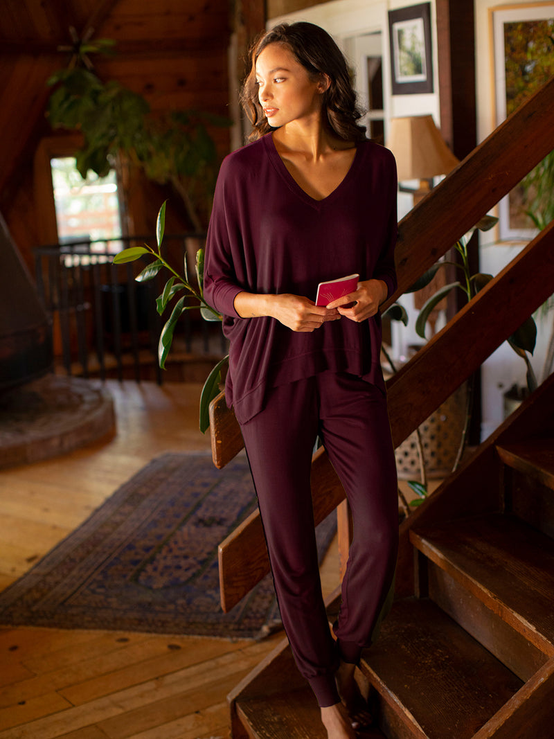 LVHR Sabina V Neck in berry. Micro modal french terry domain 3/4 sleeve top with slightly distressed rib cuff and hem and side slits. Styled with the Sabina Pant.Front.