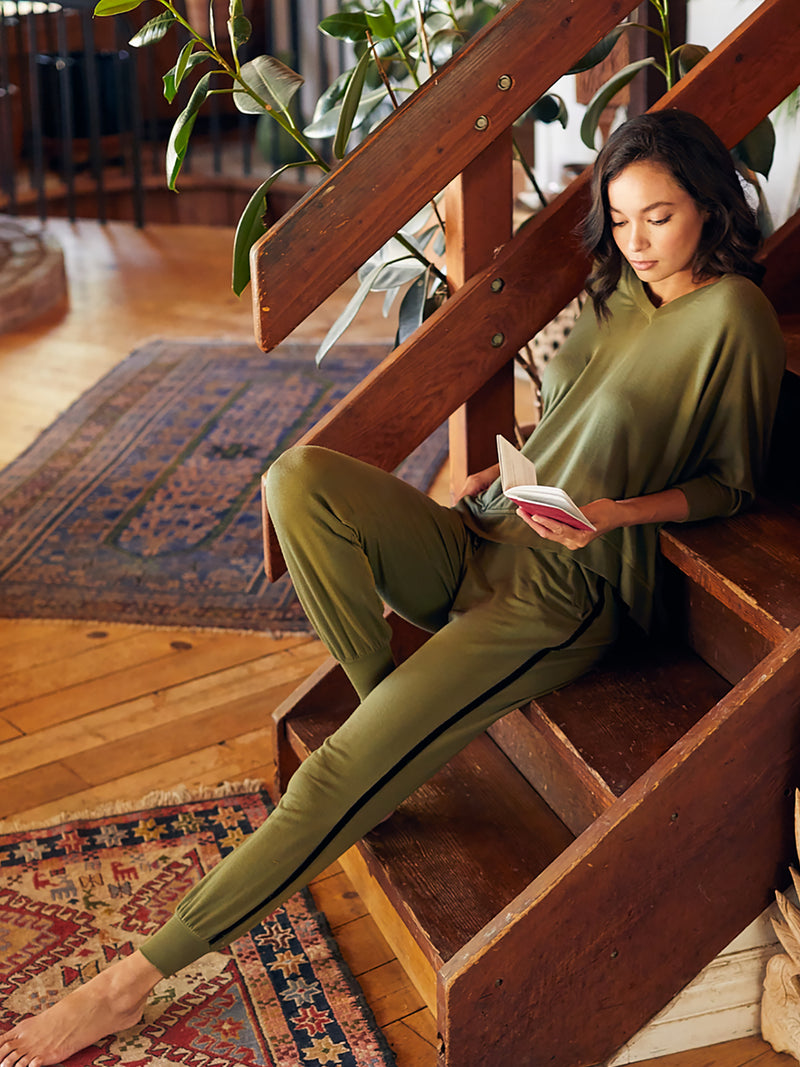 LVHR Sabina V Neck in olive. Micro modal french terry domain 3/4 sleeve top with slightly distressed rib cuff and hem and side slits. Styled with the Sabina Crop Pant. Front.
